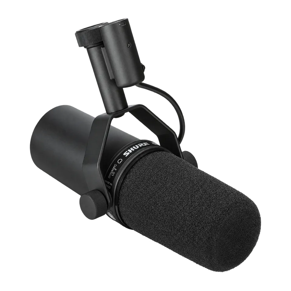 Black Shure SM7B microphone with foam windscreen and complete side mounting yoke, angled toward the front.