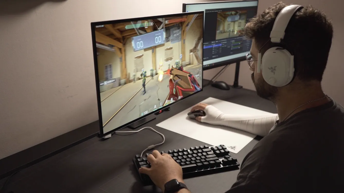 Kimmy playing a tactical shooter at his desk